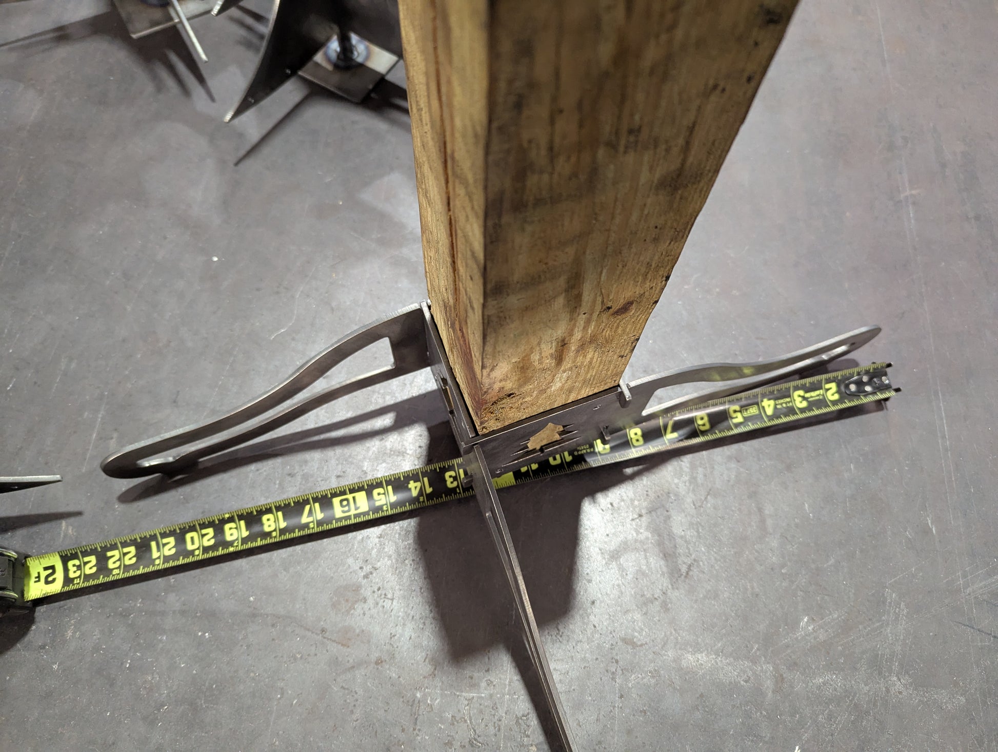 Metal Base Brackets of the Christmas Stocking Stand with a measuring tape showing the width.